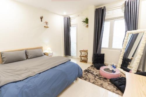 a bedroom with a bed and a large window at Cloud River Homestay in Da Lat