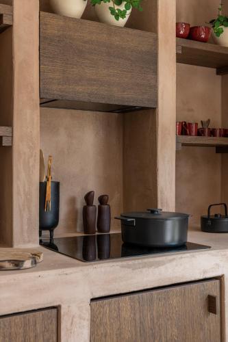 a kitchen with a stove with a pot on it at Loft Living Parkview Suite in Nieuwpoort