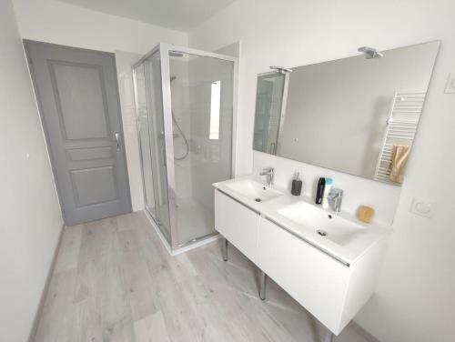 une salle de bain blanche avec un lavabo et une douche dans l'établissement Maison au calme avec parking proche centre-ville, à Orange
