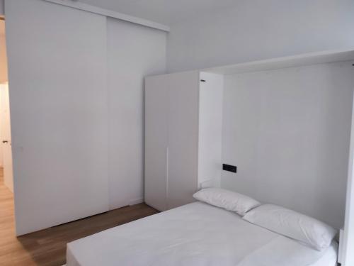 a bedroom with white walls and a white bed at MBE Premium Centro Ciudad Bilbao in Bilbao
