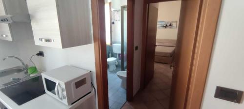 a small bathroom with a toilet and a sink at Appartamento Valentina in San Vito lo Capo