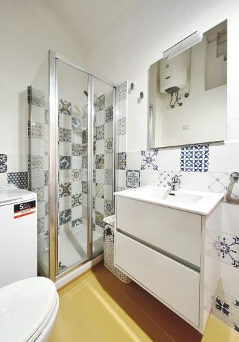 a bathroom with a shower and a sink and a toilet at Praialonga - Attico con terrazzo in Le Castella