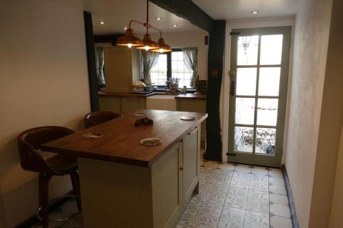 a kitchen with a island with a wooden counter top at Hathaway Hamlet in Stratford-upon-Avon