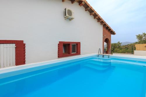 a swimming pool in front of a house at Can Prats in Ríudecañas