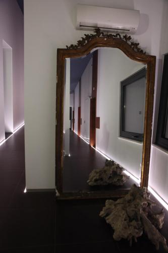 a mirror on a wall in a room at Monte Do Malhao - Art, Eco & Spa in Castro Marim