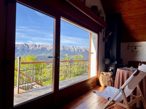 a room with a window with a view of the mountains at Casa Els Escolls in Lles