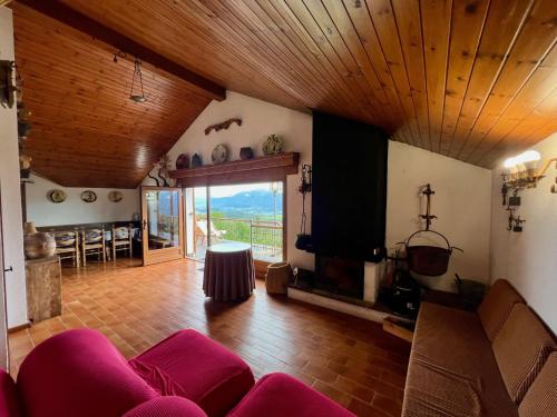 a living room with a red couch and a tv at Casa Els Escolls in Lles