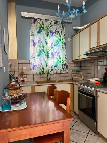 a kitchen with a table and a window in it at Voula's Apartment in Elafonisos