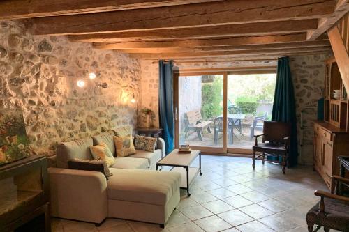 a living room with a couch and a table at Cosy flat in an old farmhouse with garden in Seynod - Welkeys in Annecy