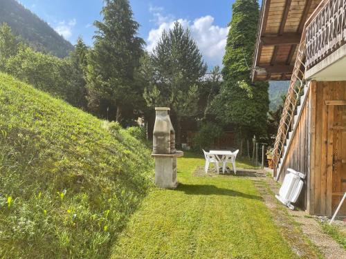 a bottle sitting in the grass next to a house at Chalet Chez Gaby 2 in Morzine