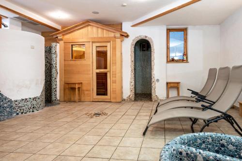 a living room with chairs and a door at Lindenhof Apt 7 in Vandoies