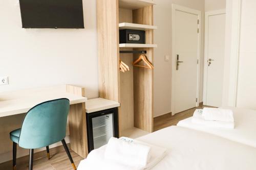 a room with a desk and a chair and a fireplace at HOTEL NARCEA in Santa Pola