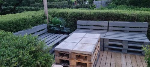 two wooden benches sitting on a wooden deck at Villa Elme in Växjö