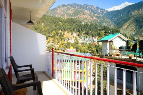 a balcony with a view of a mountain at Mitra Hostel Mcleodganj in McLeod Ganj