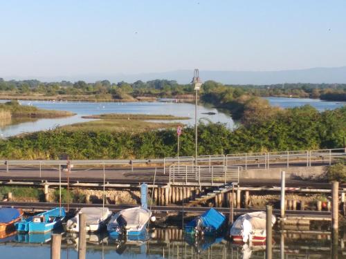 a group of boats docked next to a bridge at Ae masanete in Marano Lagunare