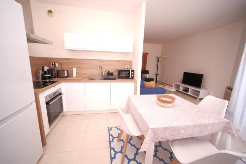 a kitchen with a table and chairs in a room at Grand F2 Bastia Centre Port de Toga, Terrasse Vue Mer in Bastia