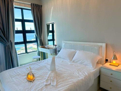 a bedroom with a white bed with a pumpkin on it at Sea Lavie Homestay@Kota Kinabalu (海旅维) in Kota Kinabalu