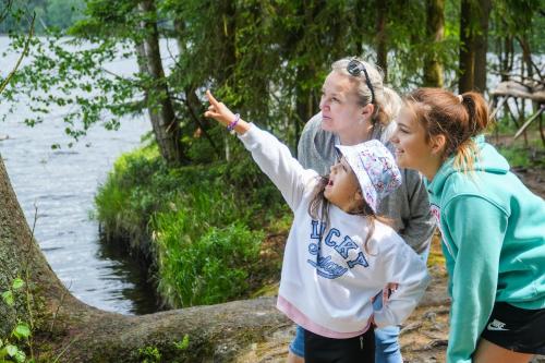 a woman and two girls pointing at a river at Ensana Butterfly in Mariánské Lázně