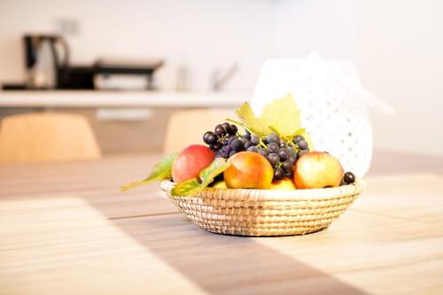 a basket of fruit sitting on a table at Zenja Apartments - Property with Cozy Garden & Free Private Parking in Divača
