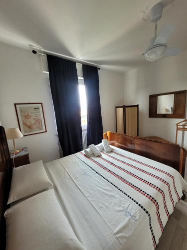 1 dormitorio con 1 cama blanca grande y ventana en Garda Best Living, en Desenzano del Garda