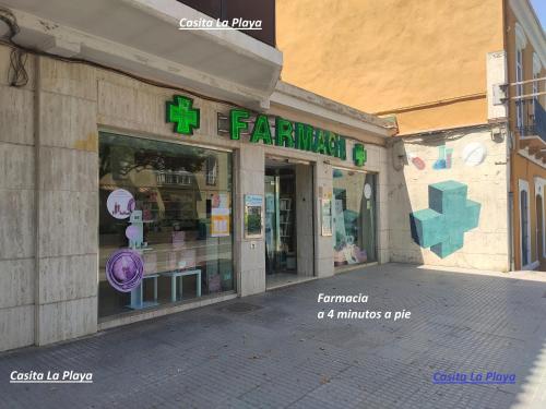 a store front of a building with a pharmacy at Casita La Playa in Málaga