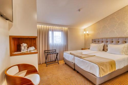 Säng eller sängar i ett rum på Hotel Lis Batalha