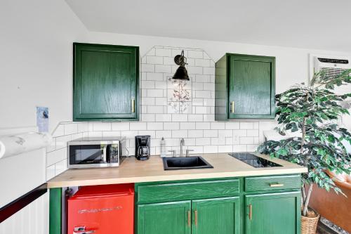 a kitchen with green cabinets and a microwave at Pine Grove Scenic View Unforgettable Love Getaway in Pine Grove