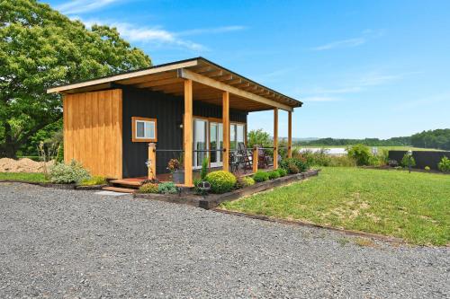 a small cabin with a porch in a field at Pine Grove Scenic View Unforgettable Love Getaway in Pine Grove