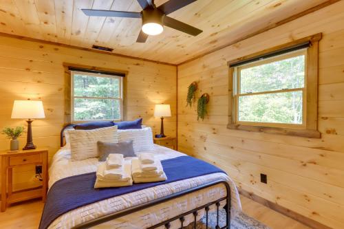 a bedroom with a bed in a log cabin at Blue Ridge Vacation Rental with Deck and Game Room! in Blue Ridge