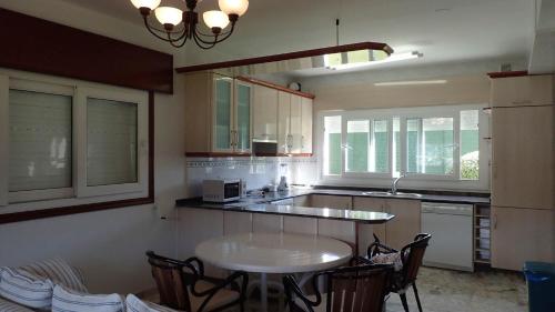 a kitchen with a table and chairs in it at Villa Roxemar en Costa da Morte in A Coruña