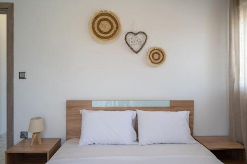 a bedroom with a bed with a heart on the wall at Nota's Home in Flogita