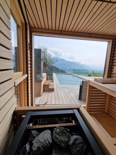 a sauna with a view of a swimming pool at Bella Flocon appartements min 2 Nights Special weekly and monthly prices in Savièse