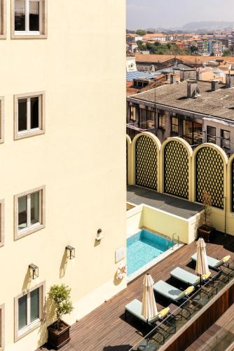 a view of the rooftop of a hotel with a swimming pool at Infante Sagres - Small Luxury Hotels Of The World in Porto