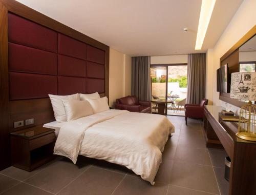 a bedroom with a large bed and a living room at Opera Hotel 
