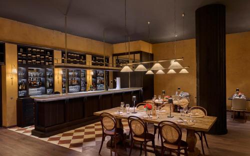 a dining room with tables and chairs and a bar at Grand Hyatt La Manga Club Golf & Spa in La Manga del Mar Menor