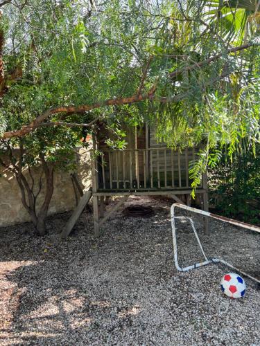a soccer ball on the ground in front of a bench at Gîte Blanche de Rouquette in Paulhan