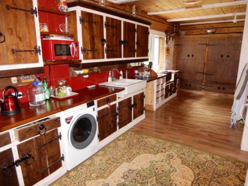 a large kitchen with a washing machine in it at Sagadi Traditional House With The Sauna And Free Parking in Sagadi
