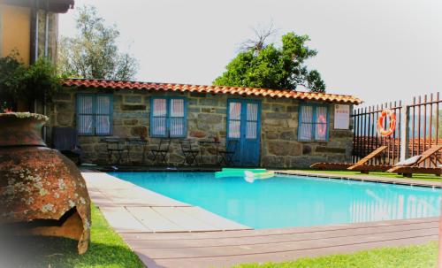 a swimming pool in front of a building at Quinta da Mó in Terras de Bouro