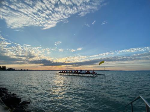 a group of people on a boat in the water at Villa Bauhaus Wellness Apart-Hotel in Siófok