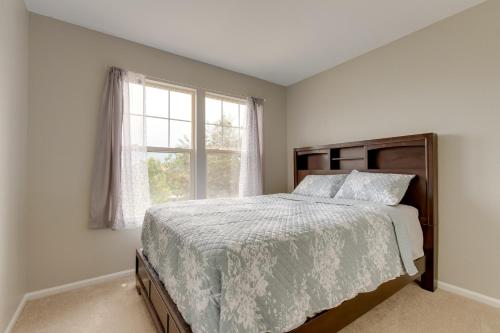 a bedroom with a large bed and a window at Spacious Aurora Home 20 Mi to Downtown Denver! in Aurora