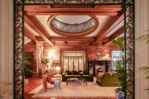a living room with a couch and a fireplace at Infante Sagres - Small Luxury Hotels Of The World in Porto