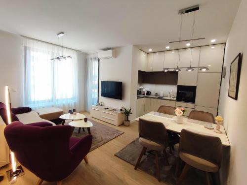 a living room with a dining table and a kitchen at Kalemegdan Park Residence - new luxury apartment in Belgrade