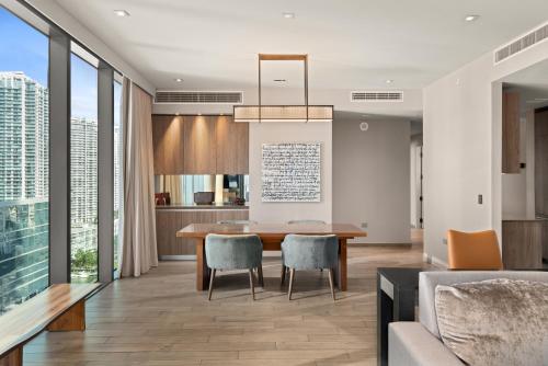 a dining room and living room with a table and chairs at EAST Miami Residences in Miami