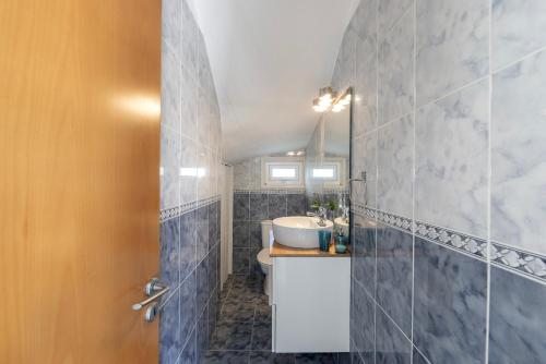 a bathroom with a sink and a toilet and a mirror at Protaras Sunrise Zen Seafront Villa in Protaras