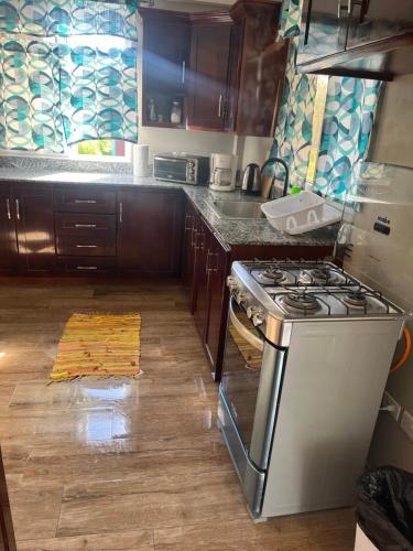 a kitchen with a stove and a counter top at 2Bedroom Vacation Home in Paix Bouche