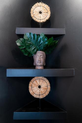 a shelf with three plates and a vase on it at MORF suites in Casale Marittimo