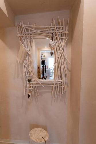 a mirror hanging on a wall with a camera at MORF suites in Casale Marittimo