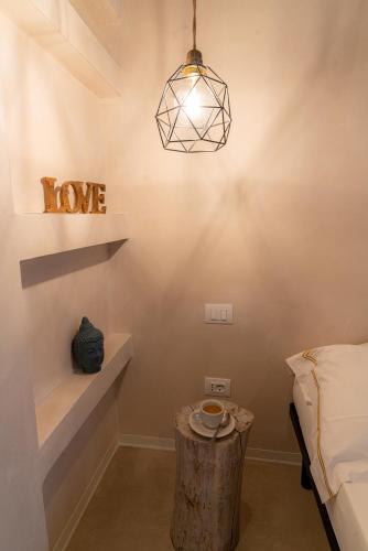 a room with a tree stump table and a light fixture at MORF suites in Casale Marittimo