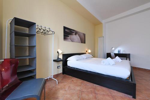 a bedroom with a bed and a book shelf at PrimoPiano - Dante in Segrate