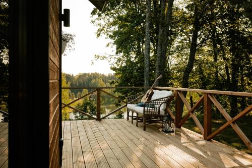 a porch with a chair on a wooden deck at Tindioru Valley Resort in Rõuge